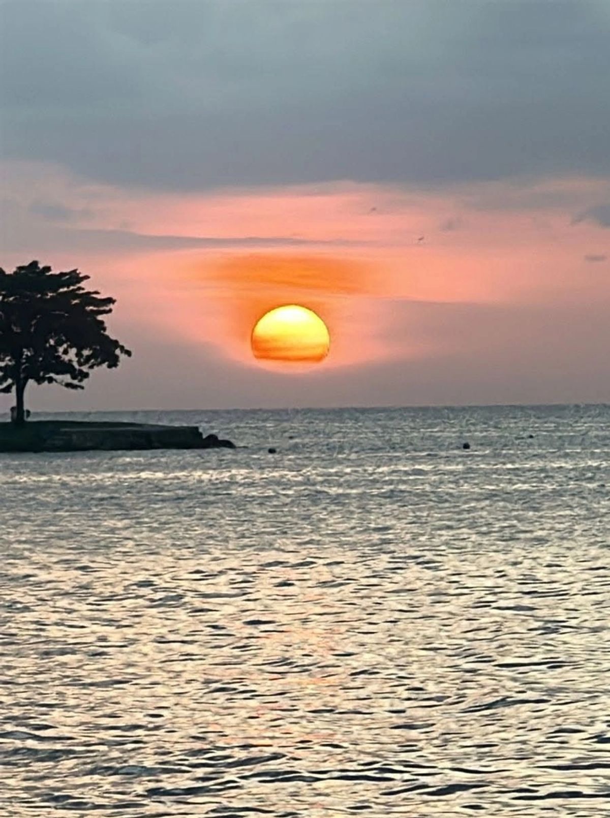 Vibrant sunset over calm Caribbean water