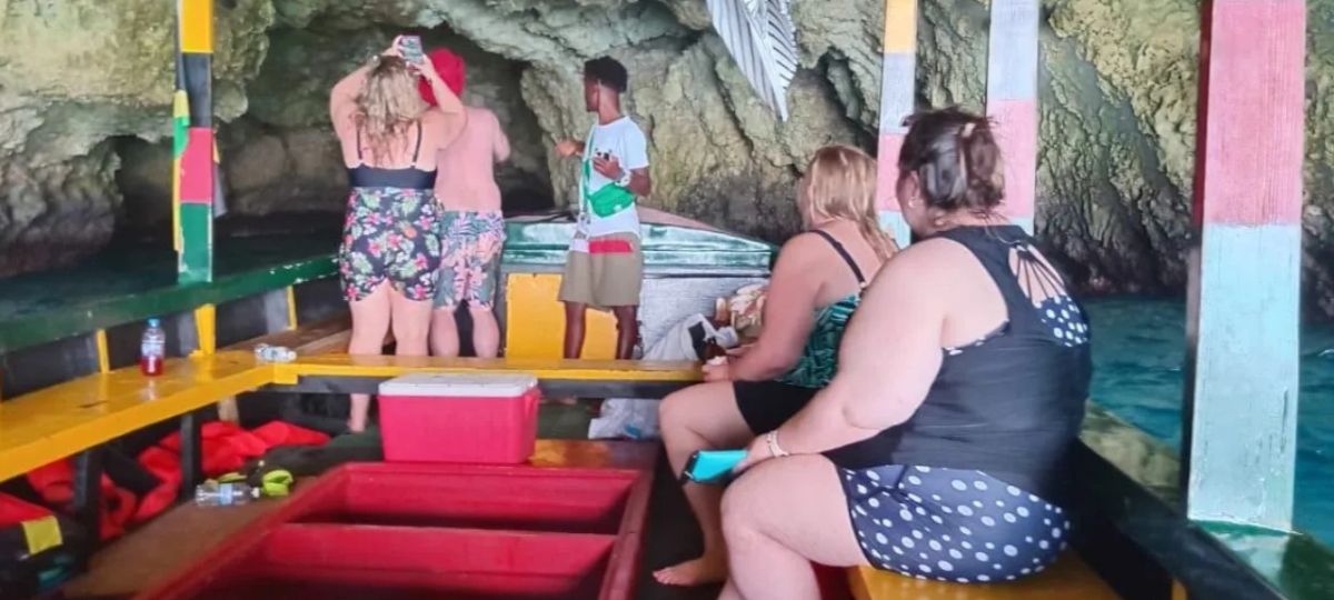 Guests riding inside a colorful boat near the caves